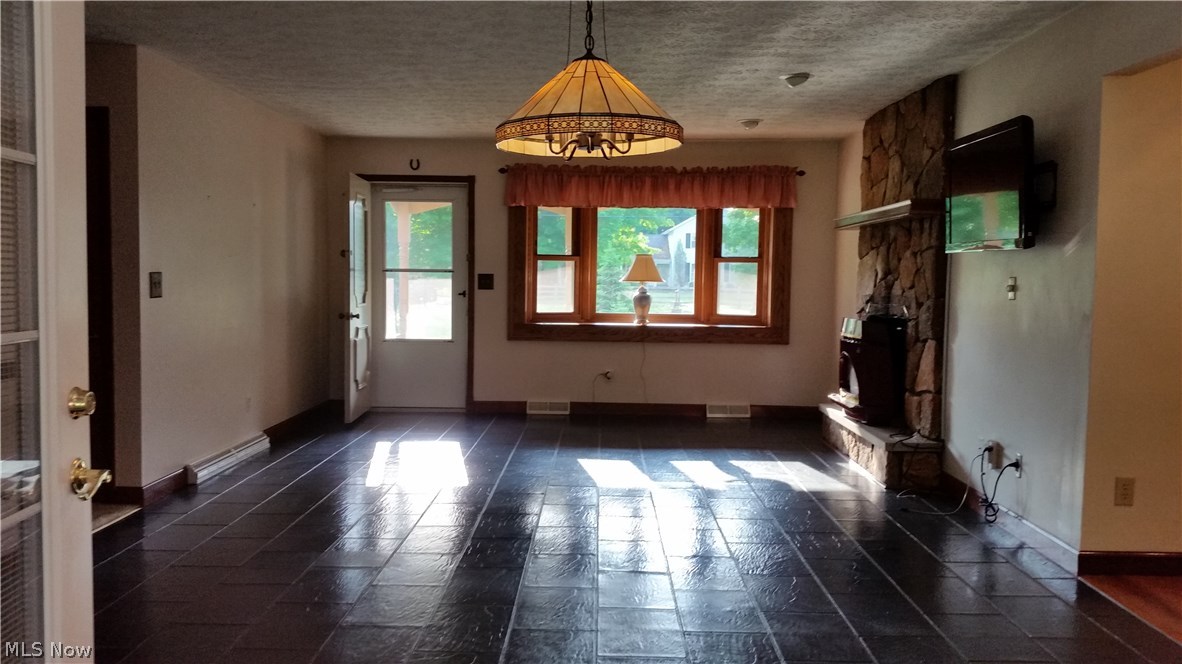 2376 Haines Road Madison, OH 44057 - Photo 5 of 30 Smooth hard surface floors gleam and offer a modern twist to a classic home. A bay window brings lots of light into this great living room. The owner left the wall-mounted television set for a new owner.