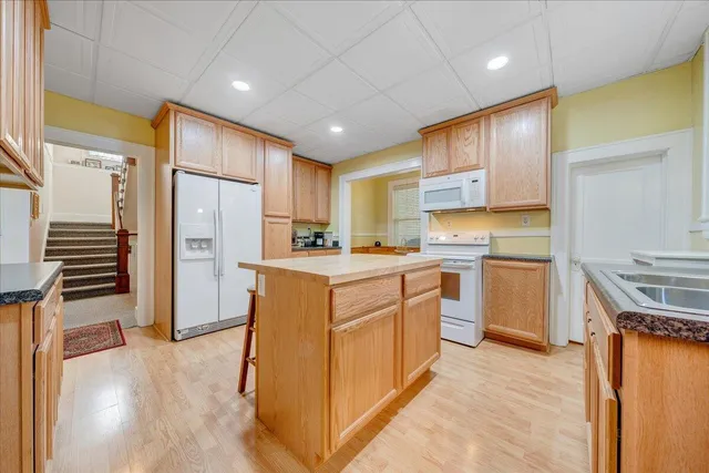 a kitchen with a refrigerator a sink and a stove top oven