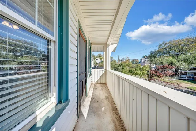 a view of a balcony with wooden floor