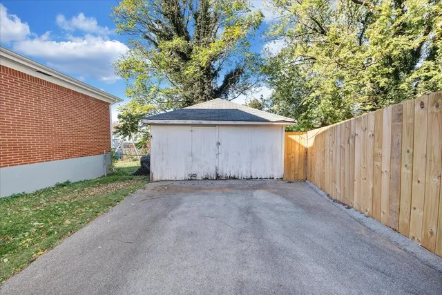 a view of a backyard with a tree
