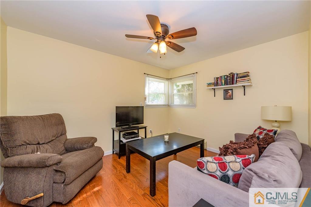 68 Sturgis Road Edison, NJ 08817 - Photo 12 of 25 a living room with furniture and a flat screen tv