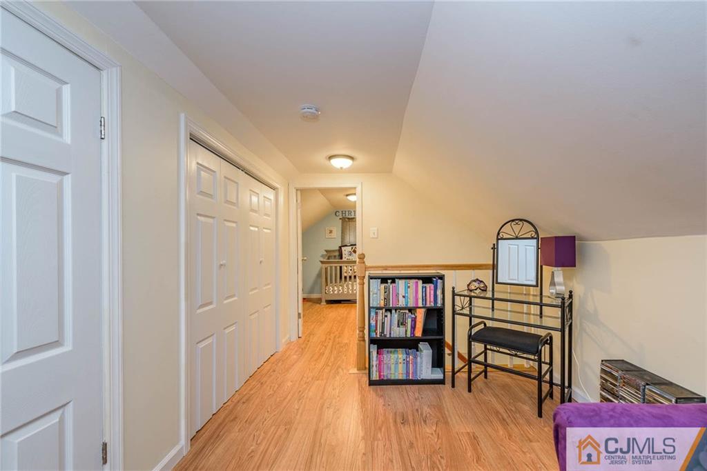 68 Sturgis Road Edison, NJ 08817 - Photo 18 of 25 a view of a hallway with wooden floor and furniture