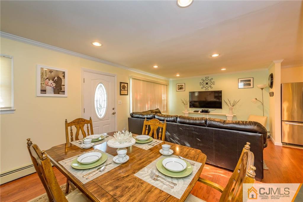 68 Sturgis Road Edison, NJ 08817 - Photo 3 of 25 a view of a dining room with furniture a rug and wooden floor