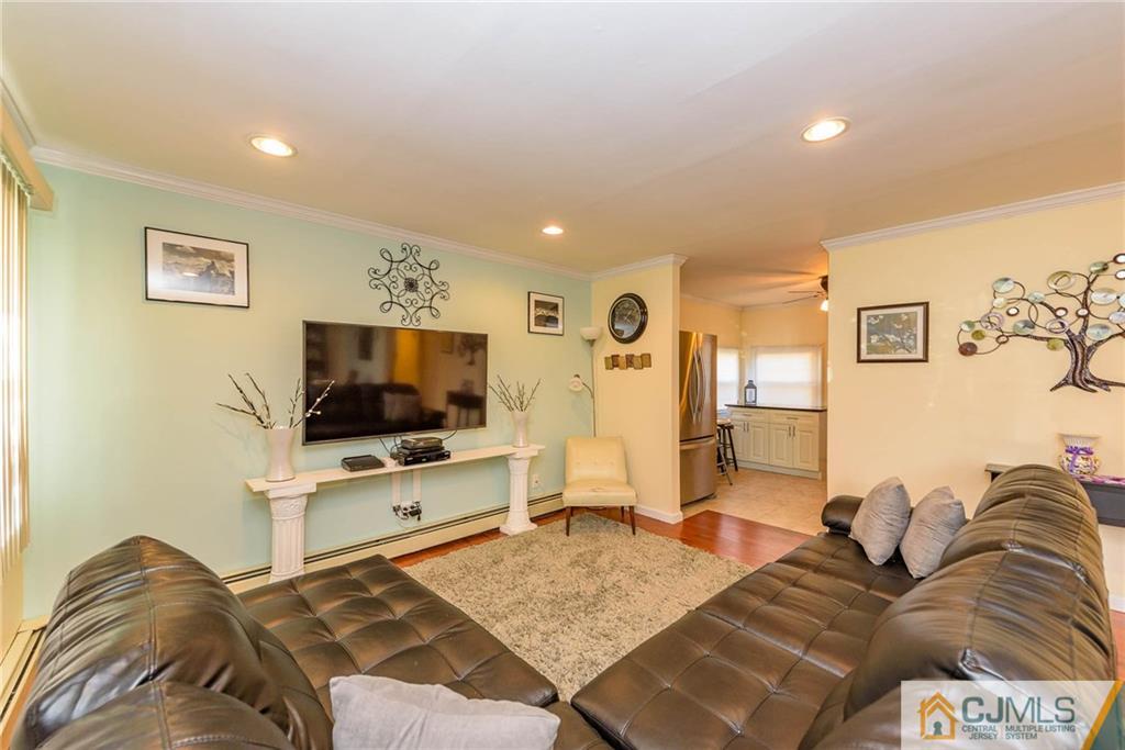 68 Sturgis Road Edison, NJ 08817 - Photo 5 of 25 a living room with furniture and a flat screen tv