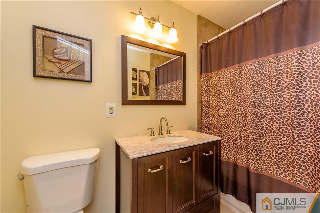 68 Sturgis Road Edison, NJ 08817 - Photo 10 of 25 a bathroom with a sink and a toilet
