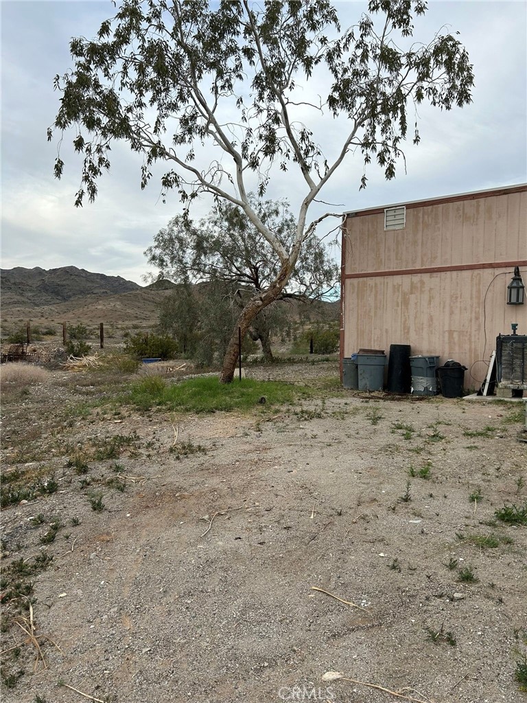 65922167 Unincorporated Parcel Needles, CA 92363 - Photo 11 of 47 a view of a dry yard with wooden fence
