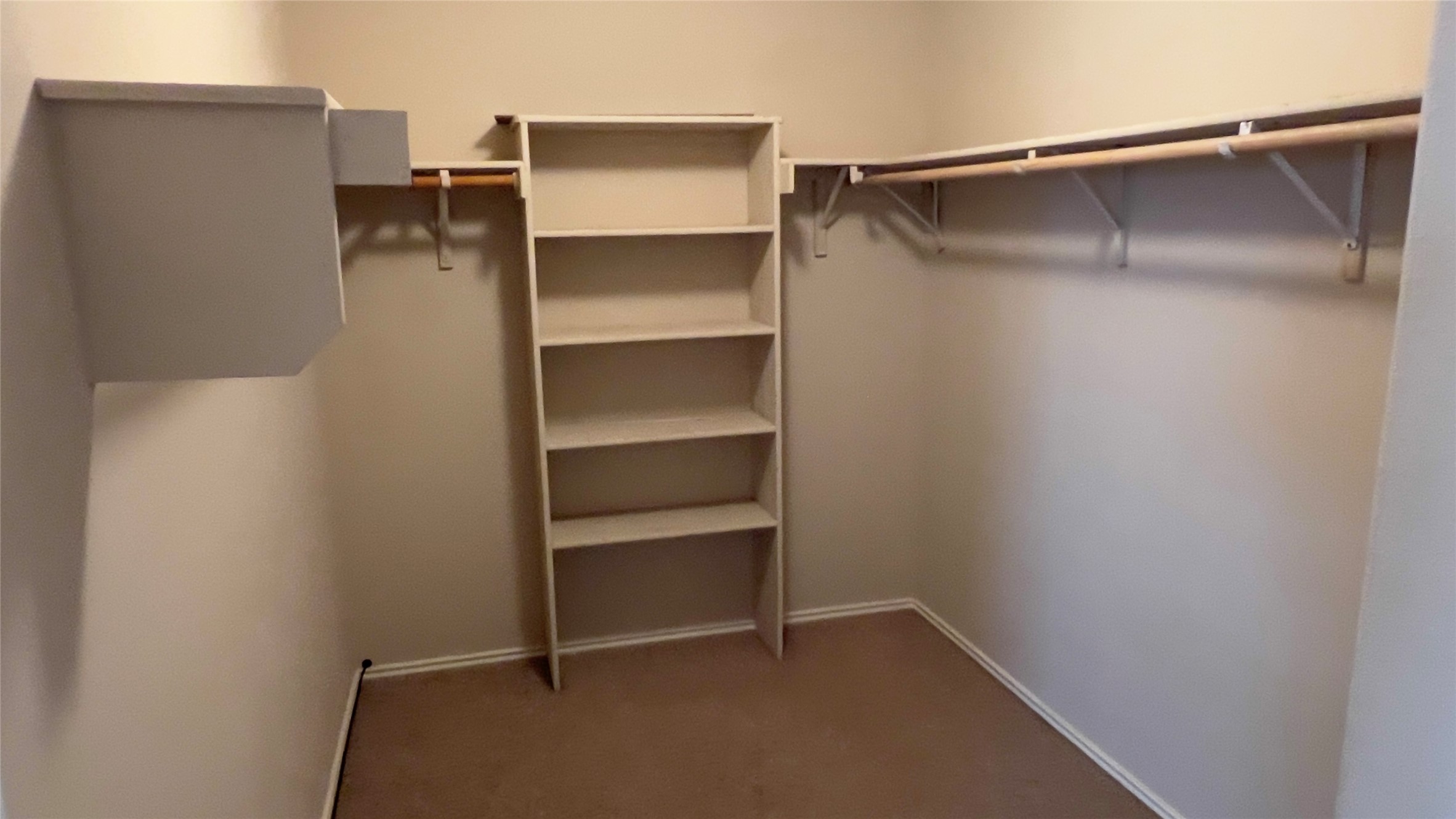 357 Nottingham Loop Kyle, TX 78640 - Photo 6 of 22 Generous built-in shelving and hanging rods maximize storage space inside this walk-in closet.