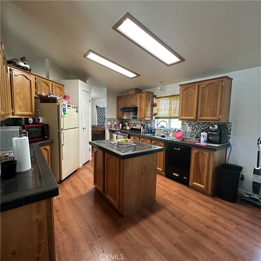 1335 Mountview Road Lakeport, CA 95453 - Photo 17 of 54 a kitchen with kitchen island granite countertop a sink cabinets and refrigerator