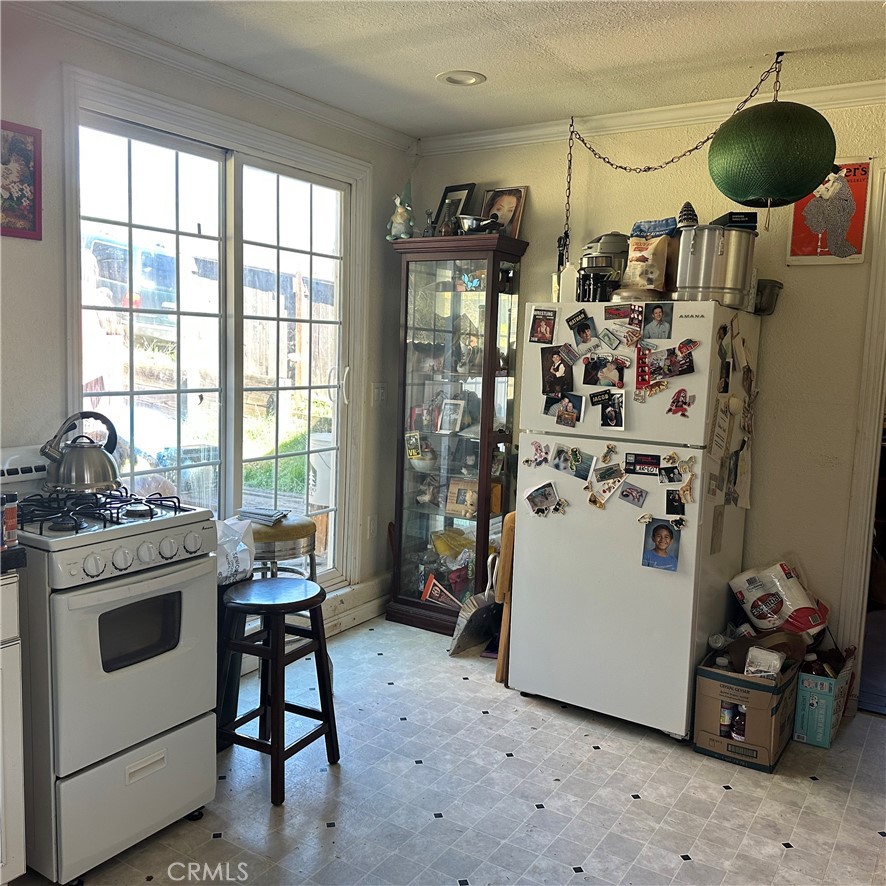 1335 Mountview Road Lakeport, CA 95453 - Photo 29 of 54 a kitchen with a refrigerator and white cabinets