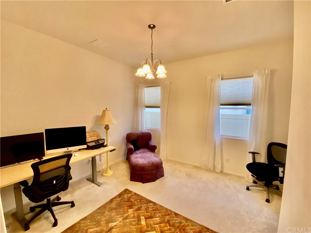 1563 Savannah Creek Beaumont, CA 92223 - Photo 17 of 28 a livingroom with workspace and a couch