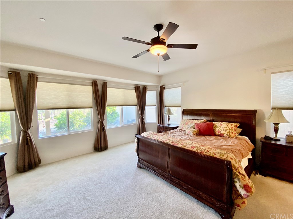 1563 Savannah Creek Beaumont, CA 92223 - Photo 18 of 28 a bedroom with a large bed and a large window