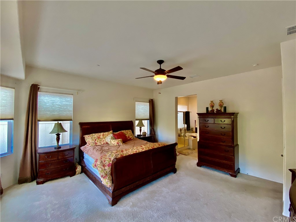 1563 Savannah Creek Beaumont, CA 92223 - Photo 19 of 28 a bedroom with a bed and a chandelier