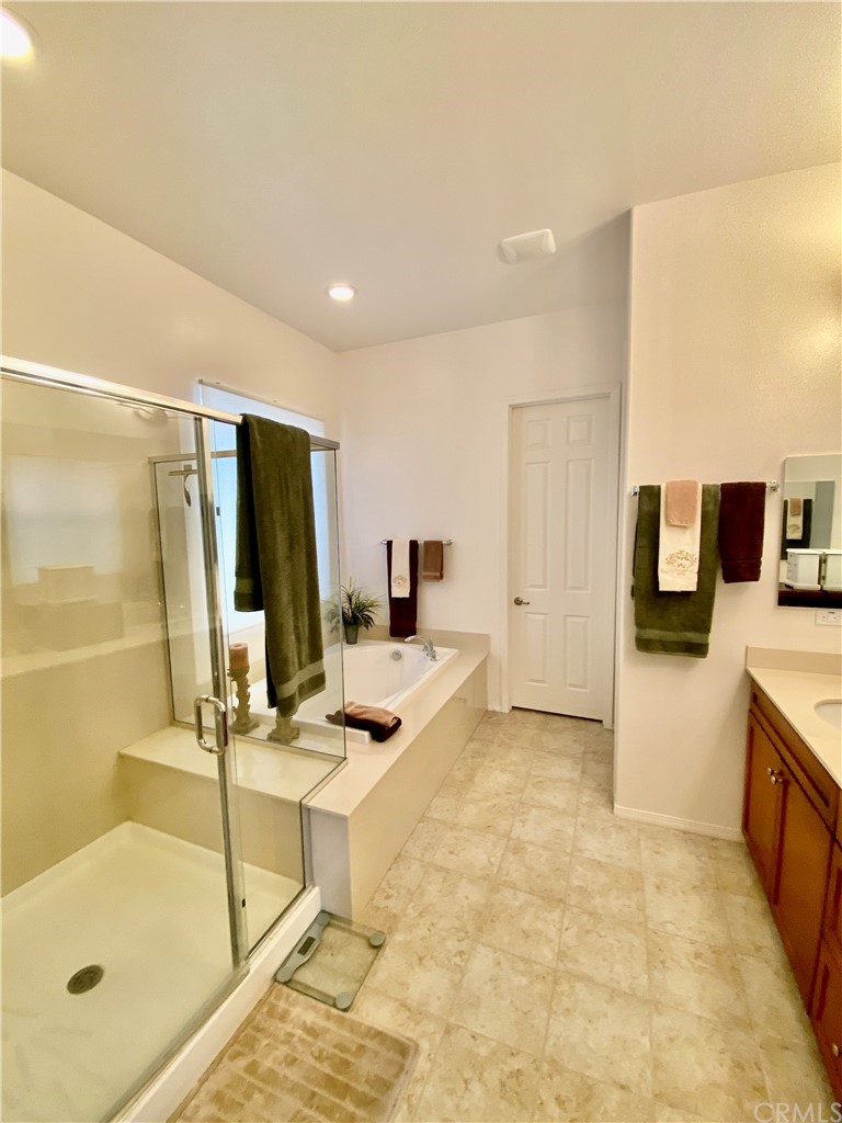 1563 Savannah Creek Beaumont, CA 92223 - Photo 21 of 28 a bathroom with a tub sink and mirror