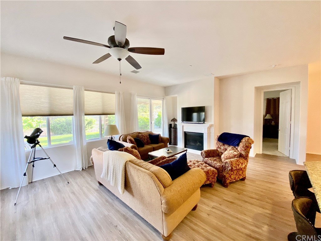1563 Savannah Creek Beaumont, CA 92223 - Photo 6 of 28 a living room with furniture fireplace and a large window