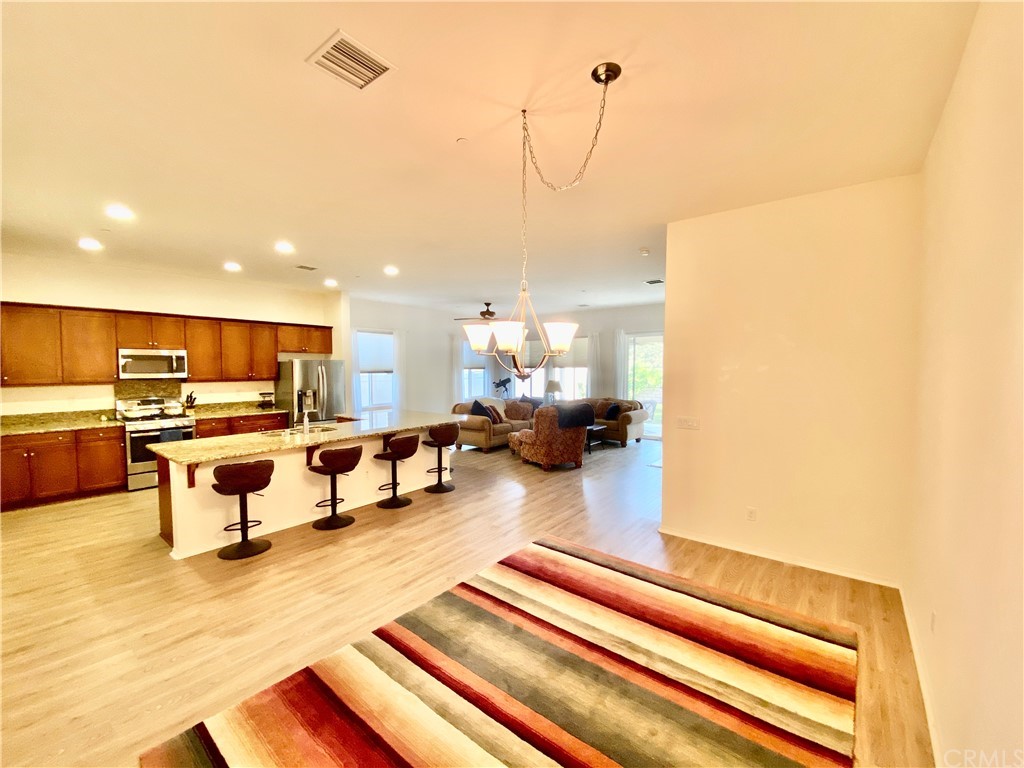 1563 Savannah Creek Beaumont, CA 92223 - Photo 8 of 28 a living room with furniture and view of kitchen