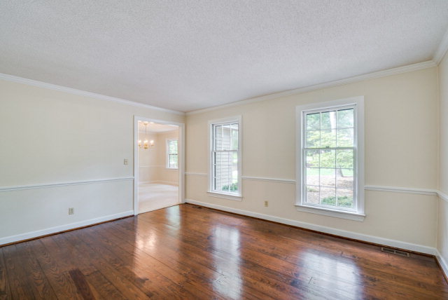 3900 Gloucester Road Rocky Mount, NC 27803 - Photo 5 of 33 The living room is bright and open with lots of light to enhance the warmth of the heart pine floors.