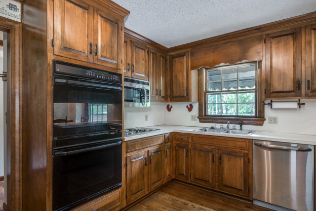 3900 Gloucester Road Rocky Mount, NC 27803 - Photo 10 of 33 Solid wood raised panel cabinets are enhanced with the stainless steel and black appliances.