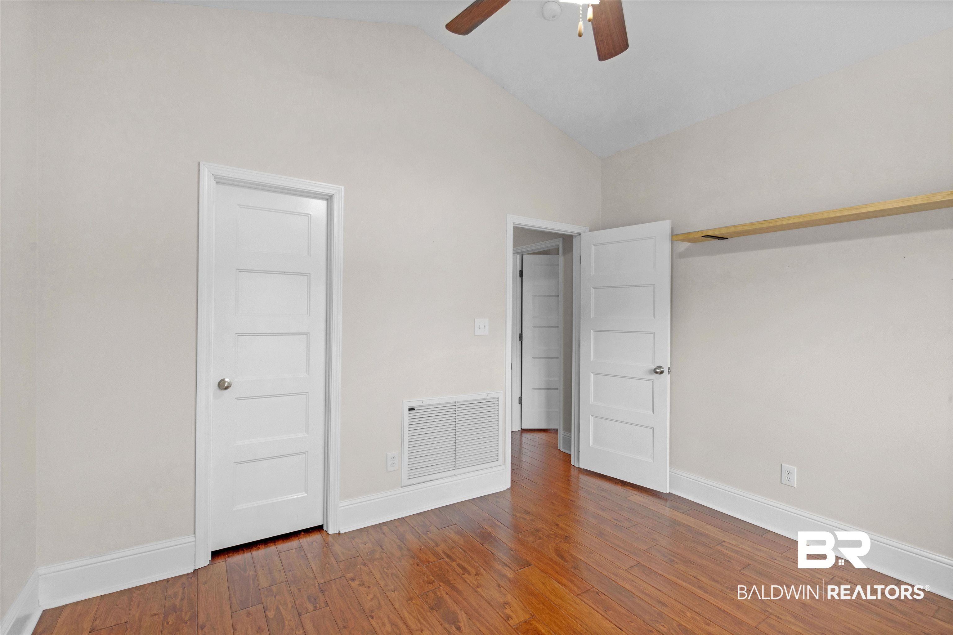 25092 Fairfax Road Daphne, AL 36526 - Photo 16 of 29 Unfurnished bedroom featuring vaulted ceiling, wood-type flooring, and ceiling fan