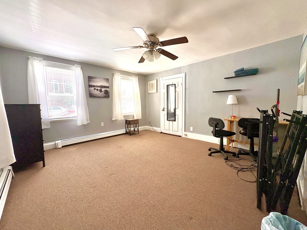 285 Roxbury Street Boston, MA 02119 - Photo 7 of 15 a view of a livingroom with a furniture and a window