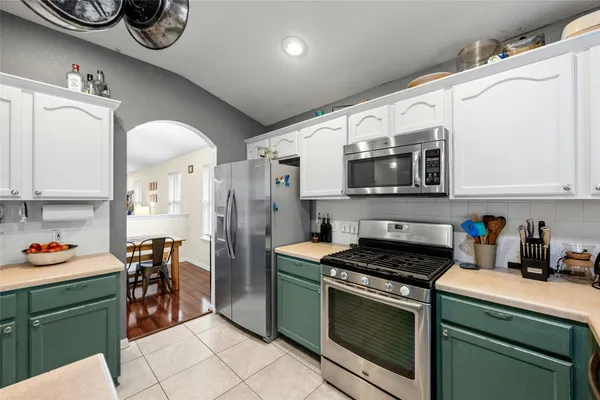 a kitchen with stainless steel appliances granite countertop a stove and a microwave