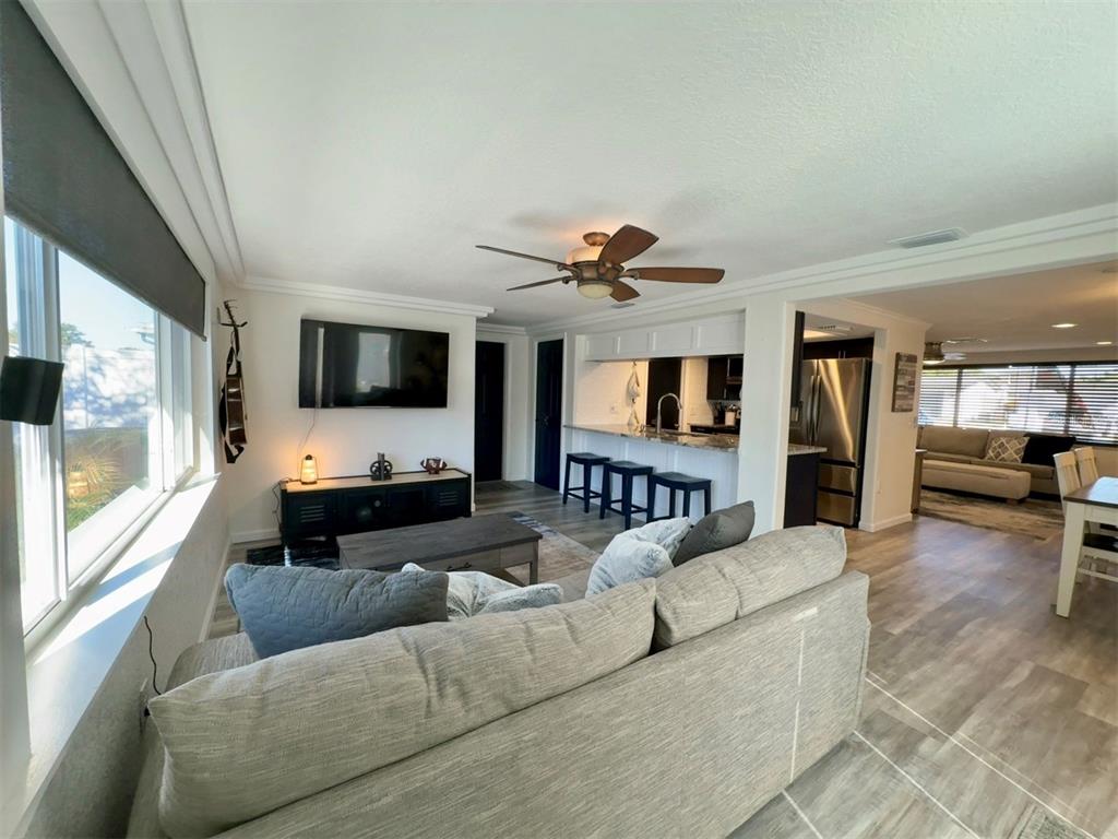 5129 Idlewild Street New Port Richey, FL 34653 - Photo 11 of 28 a living room with furniture and a flat screen tv