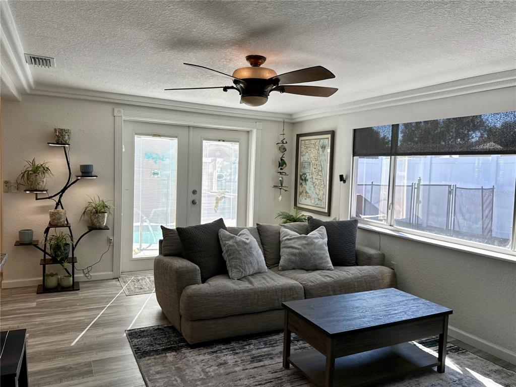 5129 Idlewild Street New Port Richey, FL 34653 - Photo 12 of 28 a living room with furniture a ceiling fan and a window