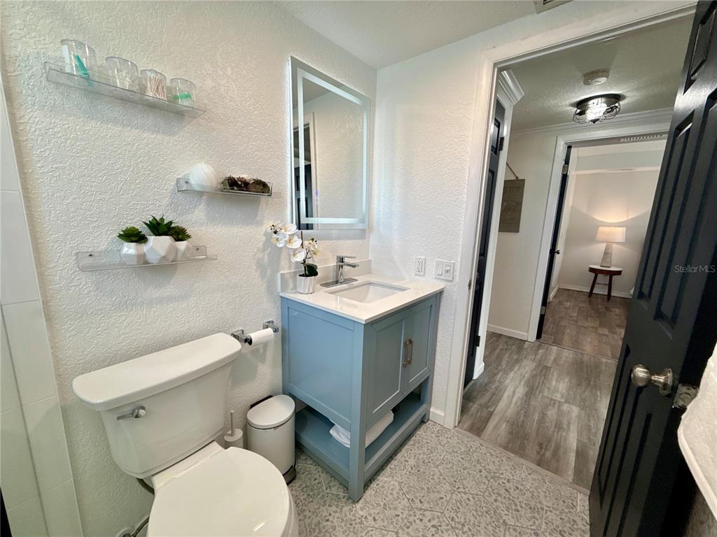 5129 Idlewild Street New Port Richey, FL 34653 - Photo 18 of 28 a bathroom with a toilet sink and mirror