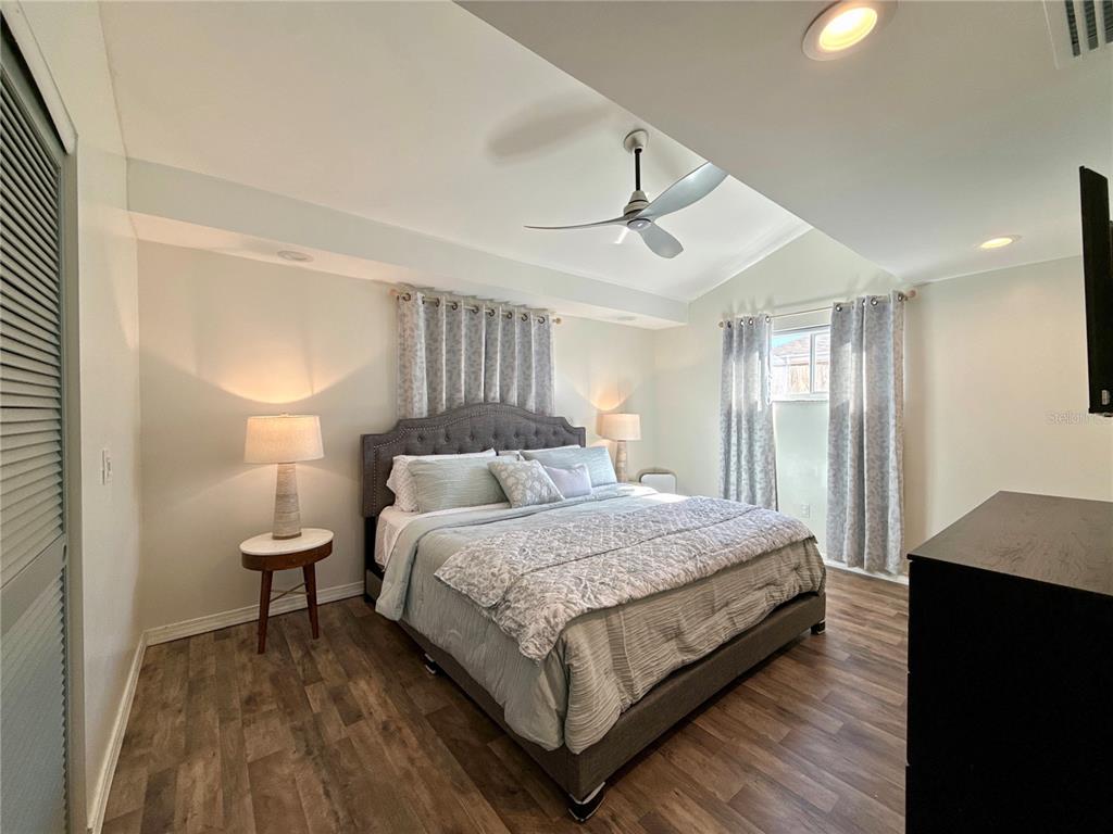 5129 Idlewild Street New Port Richey, FL 34653 - Photo 19 of 28 a bedroom with a bed and wooden floor