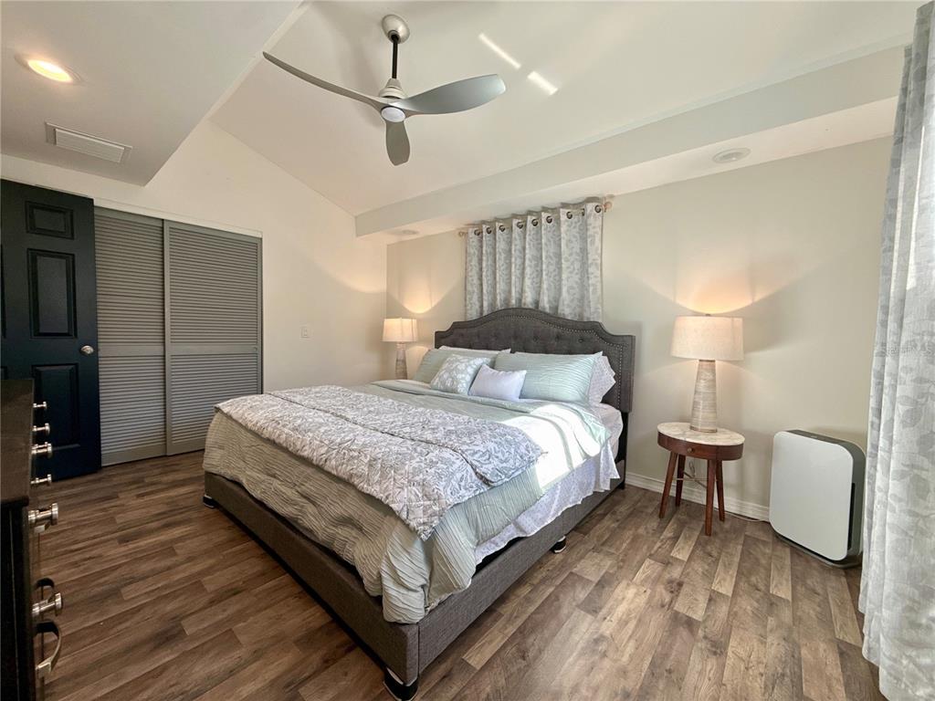 5129 Idlewild Street New Port Richey, FL 34653 - Photo 20 of 28 a bedroom with a bed and a lamp