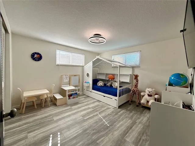 a living room with furniture and a lamp