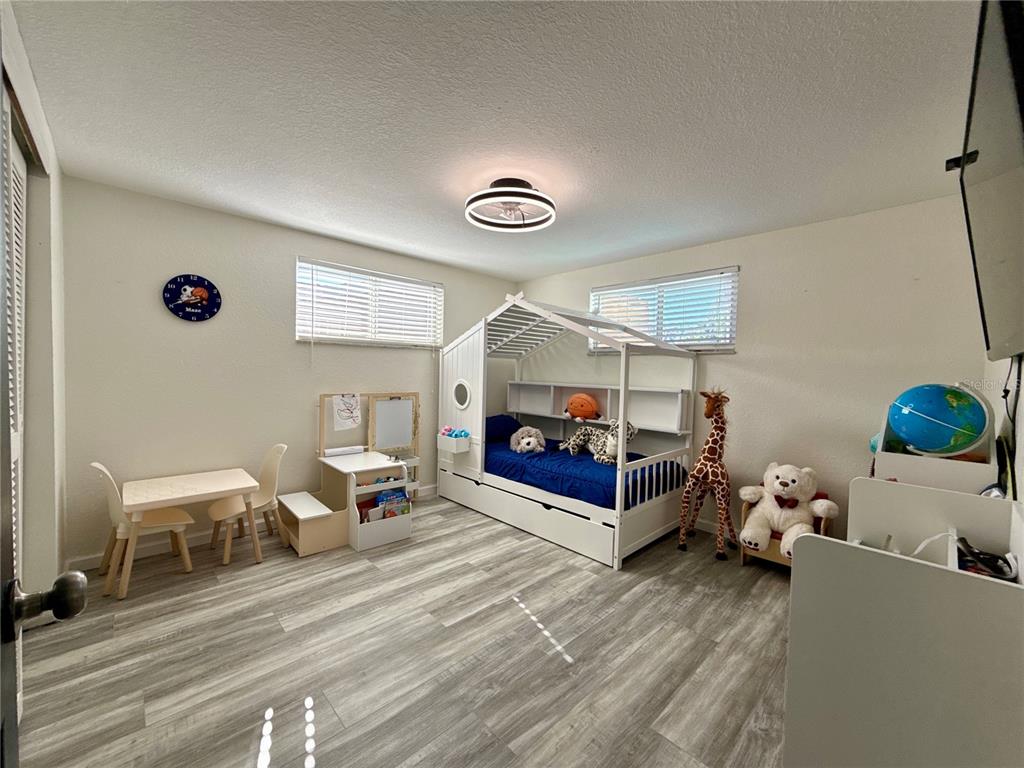 5129 Idlewild Street New Port Richey, FL 34653 - Photo 21 of 28 a living room with furniture and a lamp