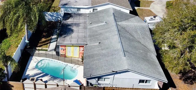an aerial view of a house with a yard and balcony