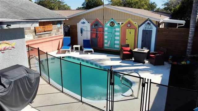 a front view of house with yard barbeque oven and outdoor seating