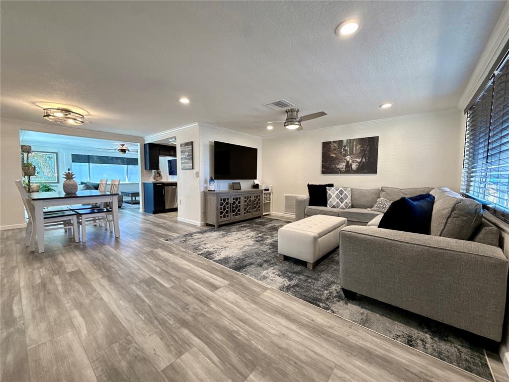 5129 Idlewild Street New Port Richey, FL 34653 - Photo 8 of 28 a living room with furniture and a flat screen tv