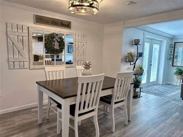 a dining room with furniture and wooden floor