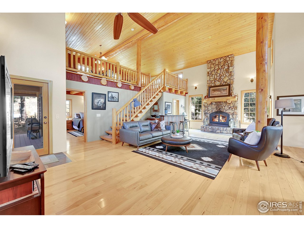 a living room with patio furniture and a fireplace