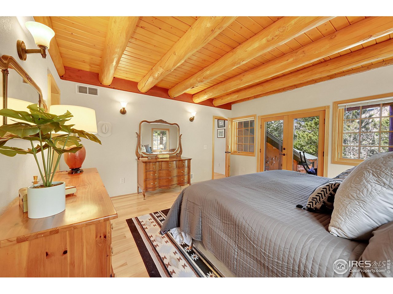 1319 County Road 83 Boulder, CO 80302 - Photo 17 of 30 a bedroom with a bed dresser and a large window