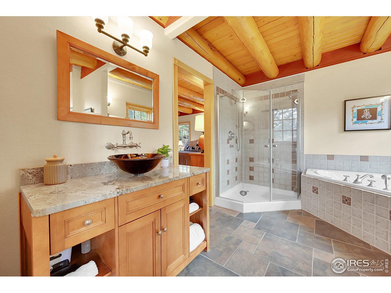 1319 County Road 83 Boulder, CO 80302 - Photo 18 of 30 a bathroom with a tub shower sink and mirror