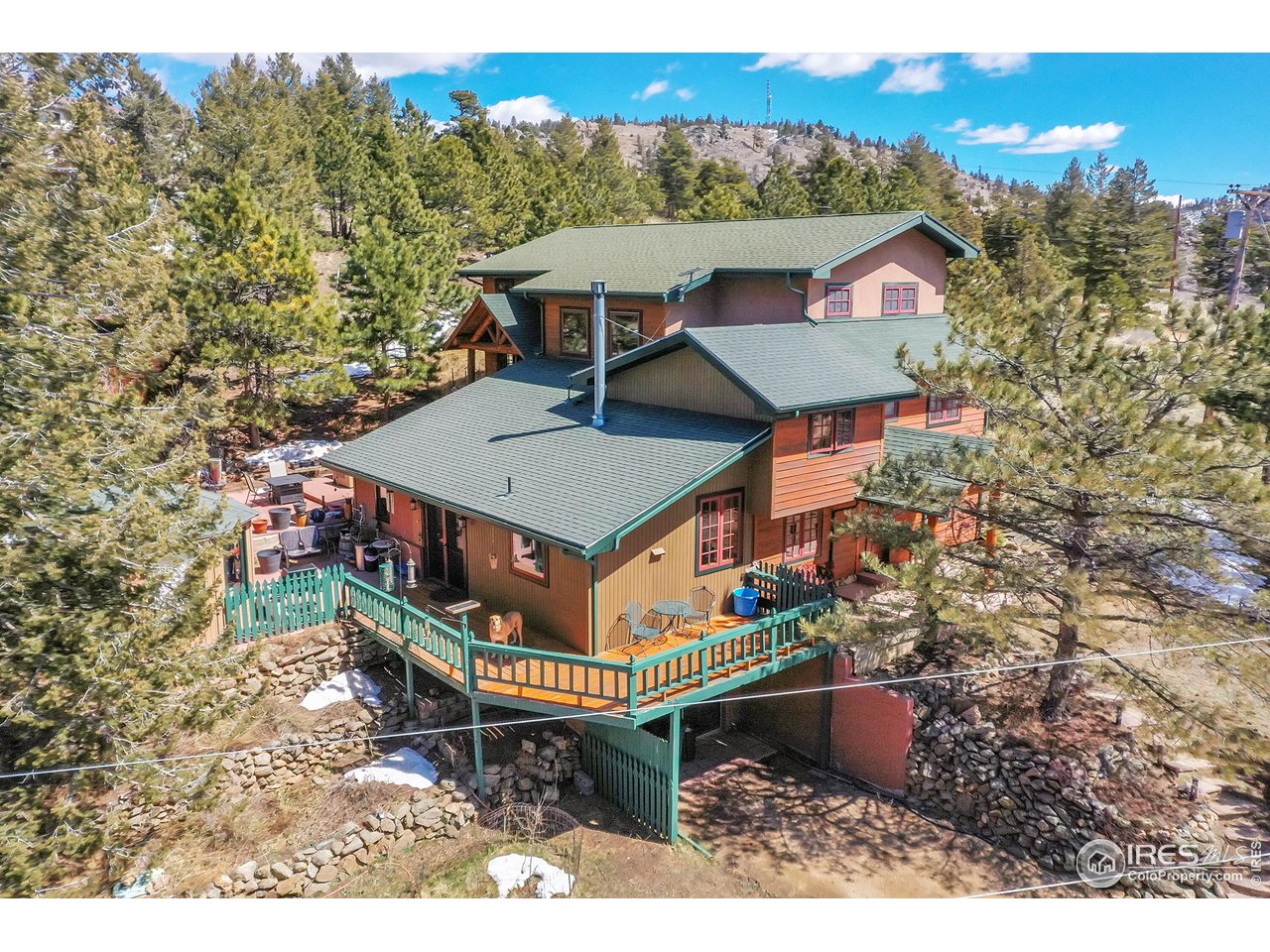 1319 County Road 83 Boulder, CO 80302 - Photo 3 of 30 an aerial view of a house with a table and chairs under an umbrella