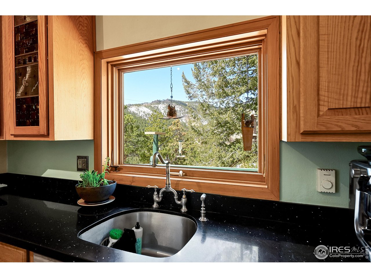 1319 County Road 83 Boulder, CO 80302 - Photo 7 of 30 a kitchen with a sink a refrigerator and a window