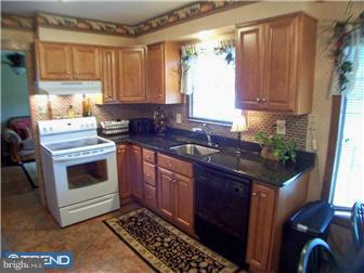 23 Tweed Road Levittown, PA 19056 - Photo 7 of 12 a kitchen with a stove and a sink