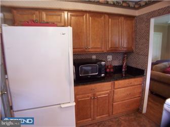 23 Tweed Road Levittown, PA 19056 - Photo 8 of 12 a kitchen with a refrigerator and cabinets