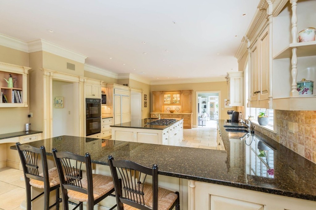 7 Brent Road Lexington, MA 02420 - Photo 9 of 14 a kitchen with granite countertop a stove and white cabinets