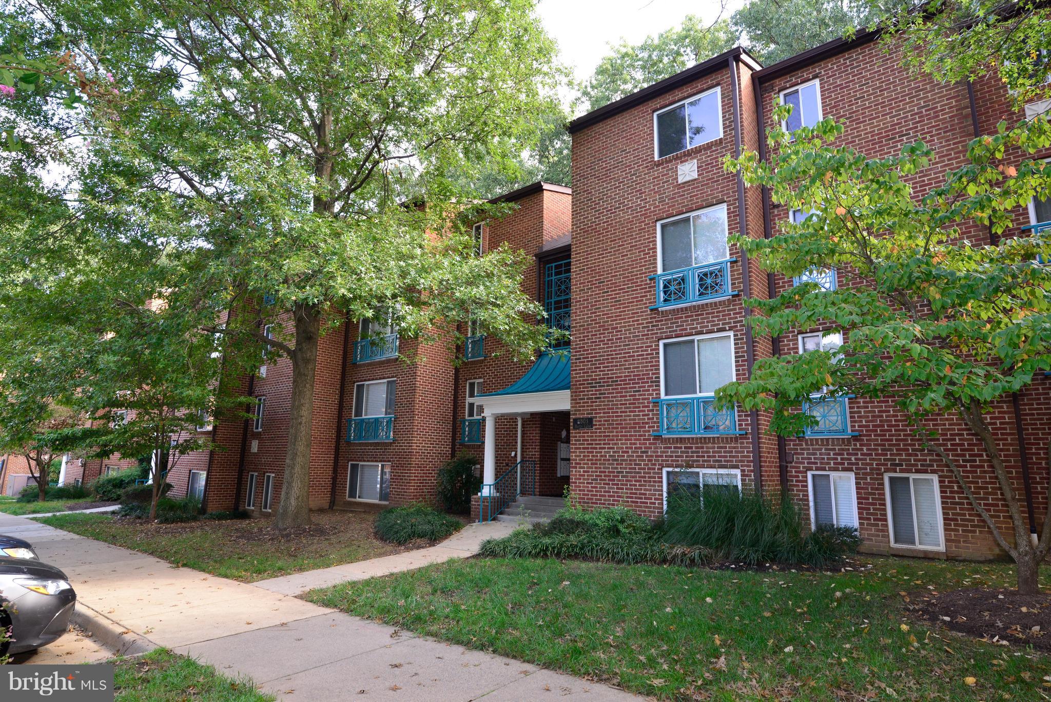 11803 Breton Court, Unit 32C Reston, VA 20191 - Photo 1 of 23 front view of a house with a yard