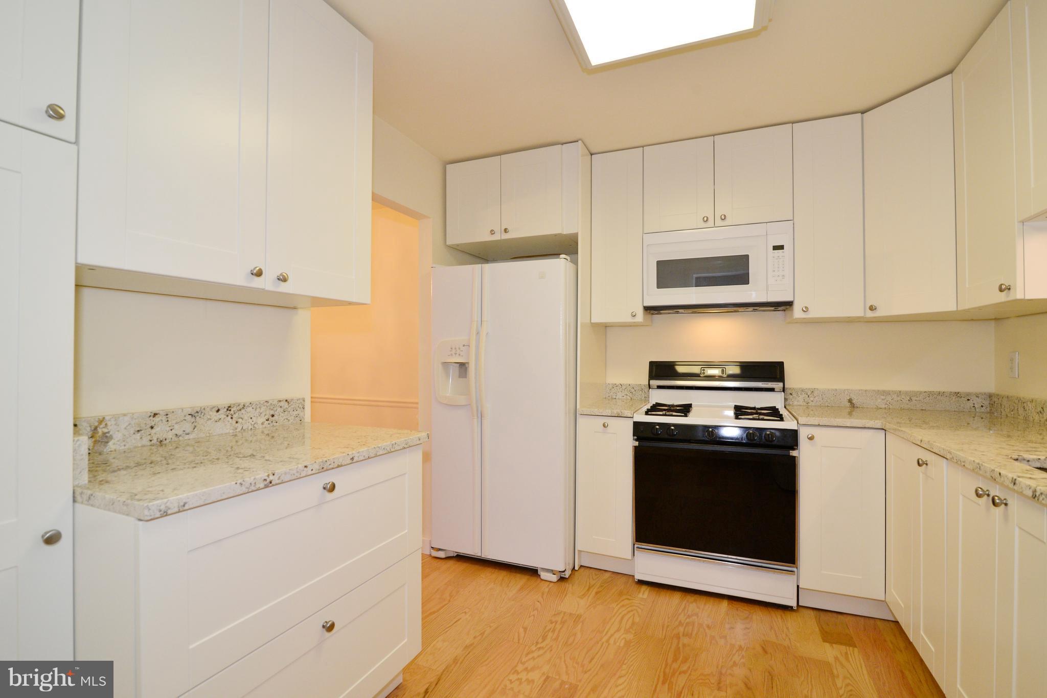 11803 Breton Court, Unit 32C Reston, VA 20191 - Photo 11 of 23 a kitchen with stainless steel appliances white cabinets and a refrigerator