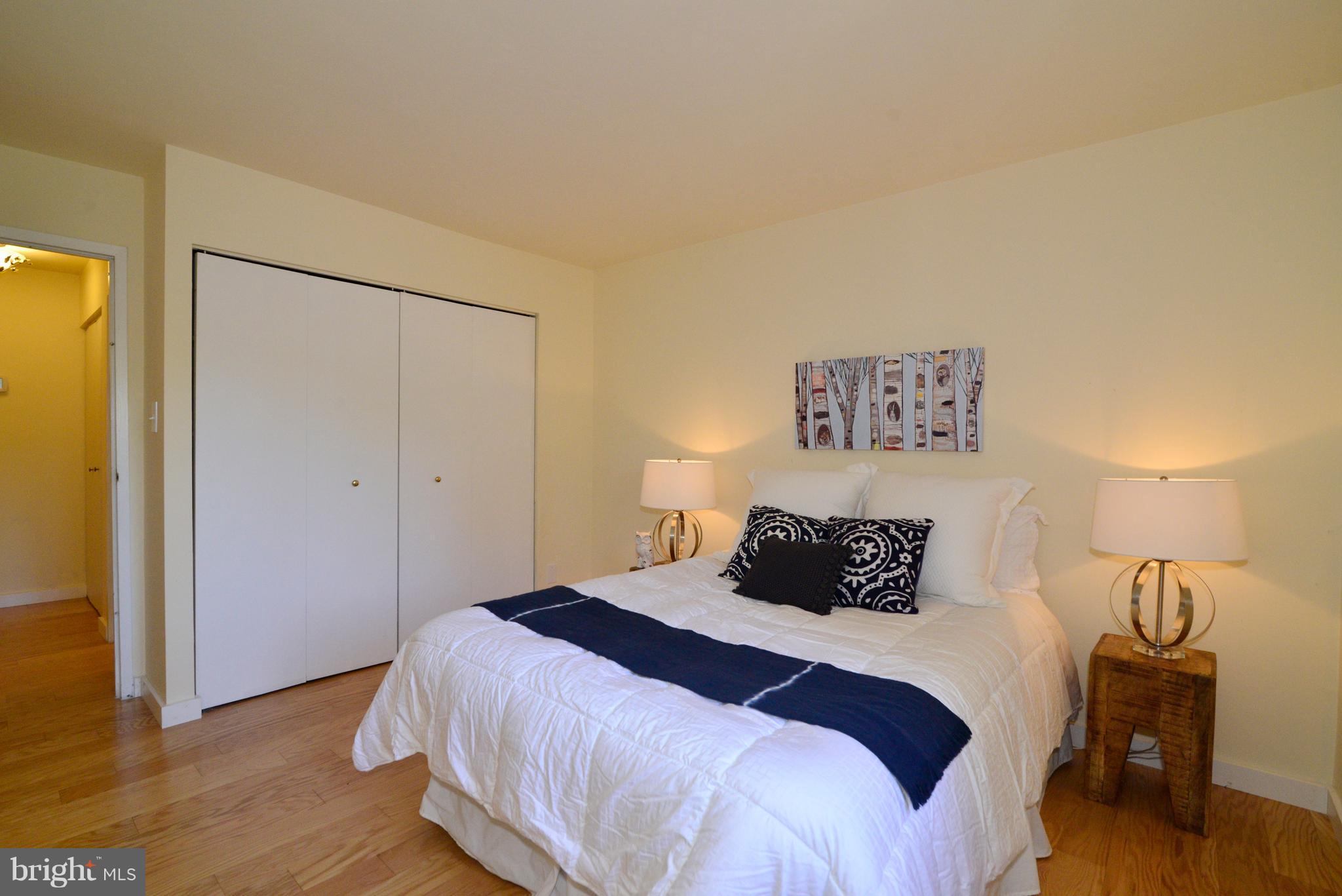 11803 Breton Court, Unit 32C Reston, VA 20191 - Photo 19 of 23 a bedroom with a bed and wooden floor