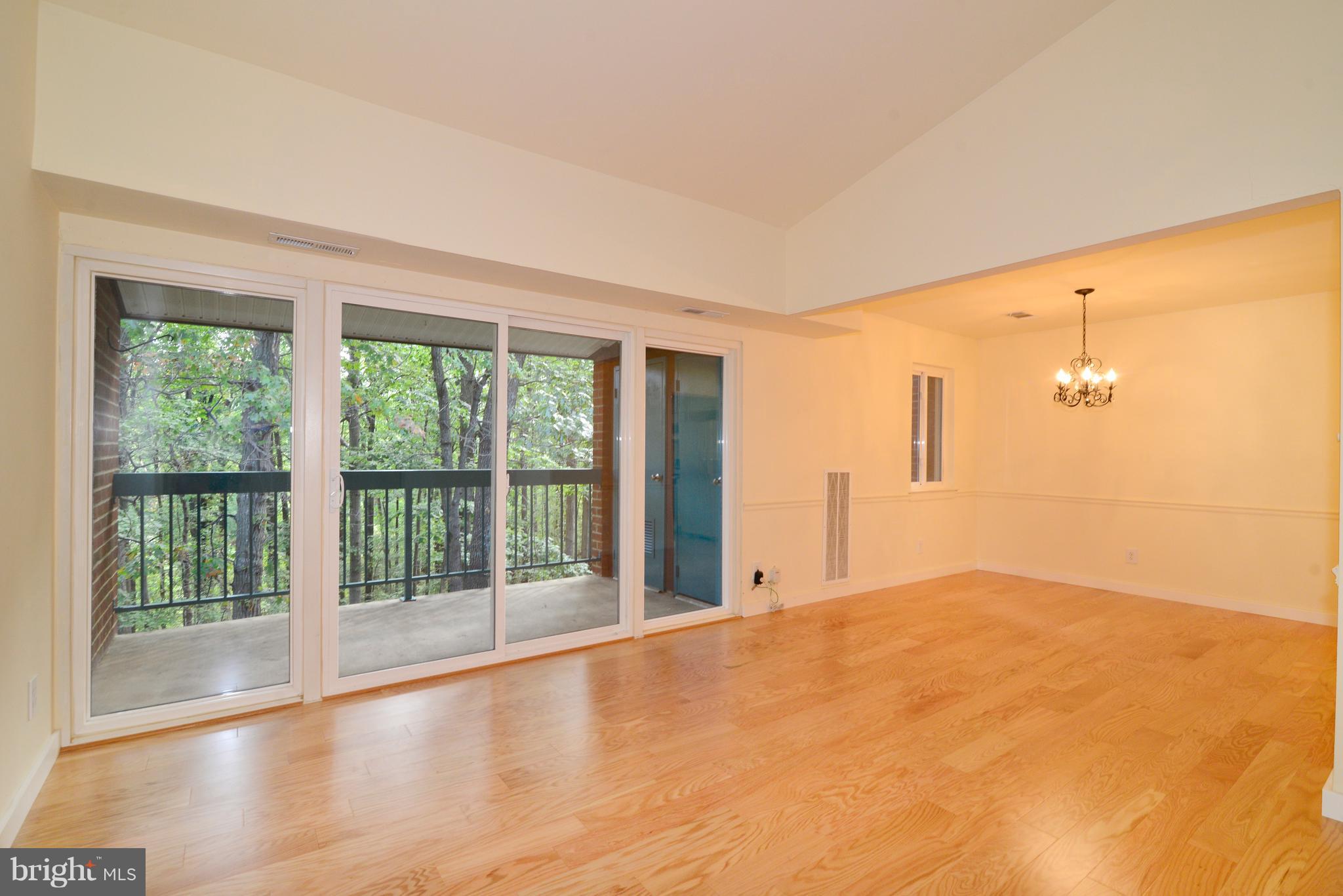 11803 Breton Court, Unit 32C Reston, VA 20191 - Photo 5 of 23 a view of an empty room with wooden floor and a window