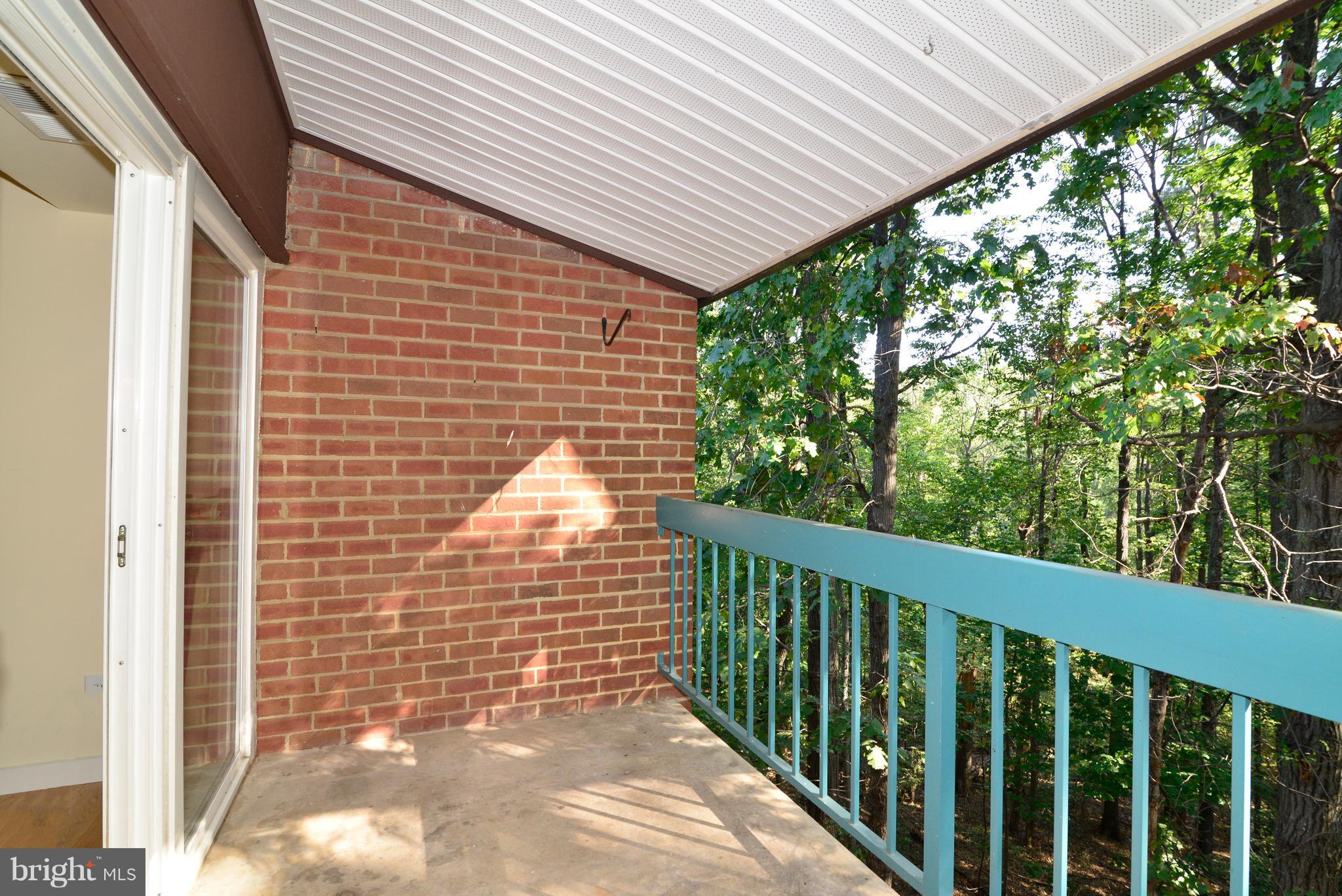 11803 Breton Court, Unit 32C Reston, VA 20191 - Photo 7 of 23 a view of a balcony with a floor to ceiling window