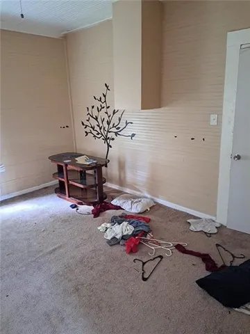 a room with furniture and view of kitchen