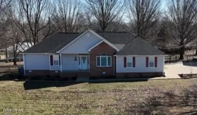a house that has a tree in front of it